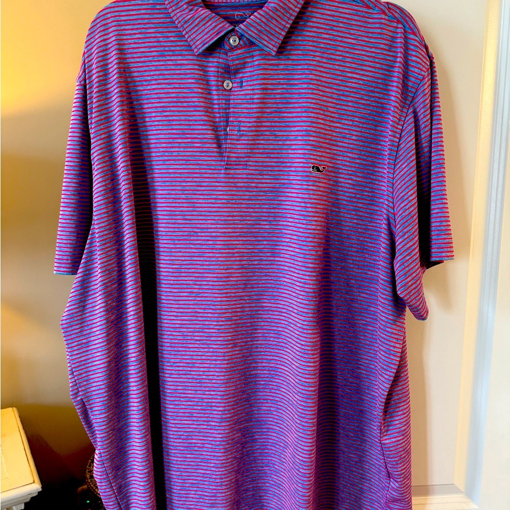 Vine Performance Polo in a blue and pink stripe.